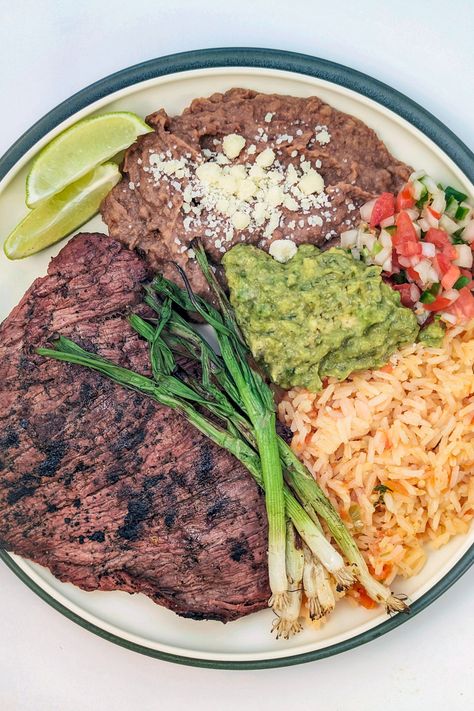 Make your own restaurant-style carne asada platter with perfectly grilled steak, rice, refried beans, guacamole, pico de gallo, and seared vegetables. Carne Asada Rice And Beans, Mexican Carne Asada Party, Mexican Food Homemade, Carne Asada Meals, Carne Asada Plate, Spanish Steak Recipes, Carne Asada Party, Carne Asada Aesthetic, Quick Mexican Dinner Ideas