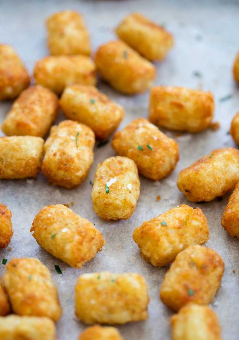 These Homemade Potato Tots are crispy, golden nuggets of deliciousness. Perfect for a midday snack or as a side dish for your favorite meal. Everyone loves Tater Tots, and making them from scratch is easier than you might think! These homemade potato tots have just 5 ingredients and are super simple to make. So you can make a batch of tots that are crispy on the outside and fluffy on the inside. Plus, you can make these in advance and freeze them. Potato Recipe For Toddler, Chinese Chicken Balls Recipe, Homemade Tater Tots, Tater Tot Recipes, Potato Tots, Shredded Potatoes, Easy Potato Recipes, Potato Bites, Potato Recipes Side Dishes