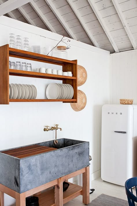 Soapstone sinks, like this one in the cottage kitchen of John and Juli Baker of Mjölk, can be treated or left to weather naturally. Wall Mounted Dish Rack, Sink Remodel, Dapur Rustic, Soapstone Kitchen, Unfitted Kitchen, Cabin Style, Stunning Kitchens, Trendy Kitchen, Kitchen Area