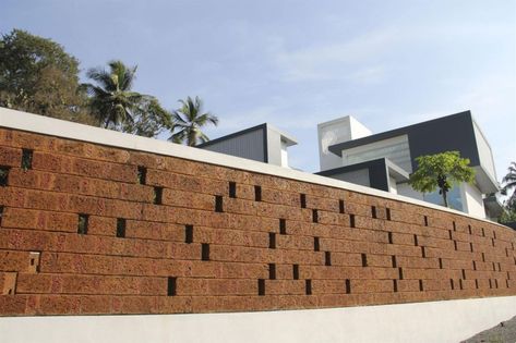 The Running Wall Residence by LIJO RENY architects | HomeDSGN Laterite Stone, Small Cottage Designs, Compound Wall Design, Concrete Block Walls, Boundary Wall, Modern Fence Design, Stone Wall Design, Complex Design, Brick Fence