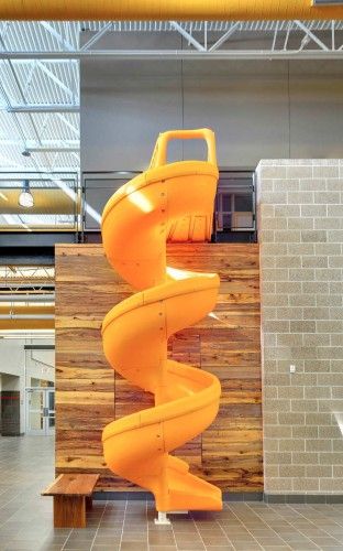 Gloria Marshall Elementary School / SHW Group. Interactive nodes throughout hallway. Pallet Sculpture, Children Architecture, Yellow Slides, Bibliotheque Design, Events Place, Indoor Slides, Stairs Architecture, School Interior, Education Architecture