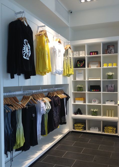 Merch Wall Display, Gym Merchandise Display, Apparel Display, Merchandise Display, Dance Store, Clothing Store Displays, Soul Cycle, Clothing Store Interior, Yoga Studio Design