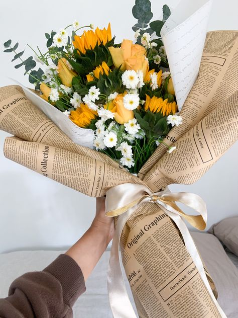 Sunflower wrapped bouquet Sunflower Bouquet Wrapped In Paper, Bouquet In Newspaper, Bouquet Wrapped In Newspaper, Flower Bouquet Newspaper, Flowers In Newspaper Bouquets, Flowers In A Paper Bag, Newspaper Wrapped Bouquet, Flower Bouquet Newspaper Wrap, Newspaper Bouquet Wrap