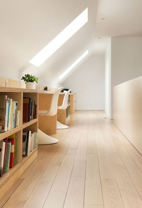 a shared attic home office in minimalist style, with skylights, a long shared desk with storage, white sculptural chairs is clean and airy Plywood Stairs, Renovated Attic, Residential Architecture Facades, Residential Architecture Apartment, Attic Office, House Concept, Office Design Inspiration, Angled Ceilings, Sculptural Chair