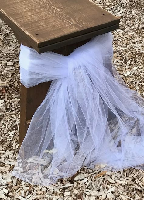 Tulle tied to the ends of wedding guest benches along the aisle for rustic outdoor wedding Outdoor Wedding Bench Decor, Bench Aisle Decor, Ceremony Flowers Aisle Shepherds Hook, Wedding Isles Decoration Outdoor Benches, Wedding Ceremony Benches Decor, Bench Decorations Wedding, End Of Bench Decor Wedding, Bench Decor For Wedding, Wedding Aisle Benches Decor