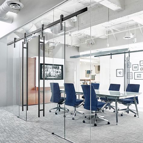 The Ragnar sliding door hardware system was designed with glass in mind. With a suite of adjustment features, it's perfect for curtain wall glass installations like this one from OFS. Office Meeting Room, Modern Barn Door, Glass Walls, Office Meeting, Office Snapshots, Modern Barn, Corporate Office, Barn Door Hardware, Office Interior Design