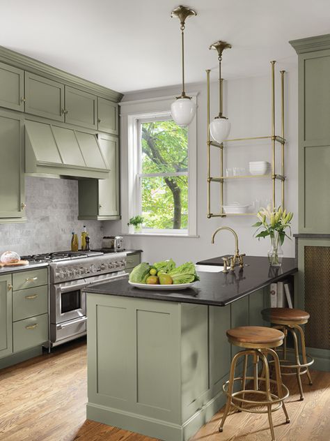 The homeowners originally requested an all white kitchen. As the layout came together Smith threw the couple a curve ball and suggested a nature-inspired, green color for the cabinetry. “To my surprise, they loved the idea,” she says. “The green still reads very neutral but introduced a little something extra. Sometimes it reads gray, sometimes olive or sage.” Modern Kitchen Shelves, Green Kitchen Cabinet, Olive Green Kitchen, Green Kitchen Island, Cabinet Trends, Sage Kitchen, White Wood Kitchens, Kitchen Cabinet Trends, Sage Green Kitchen