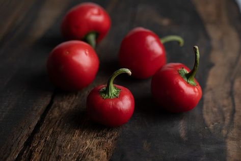 Cherry Bomb peppers Cherry Bomb Pepper, Cherry Bomb, Dark Background, Peppers, Food Photography, Good Food, Cherry, Stuffed Peppers, Photography