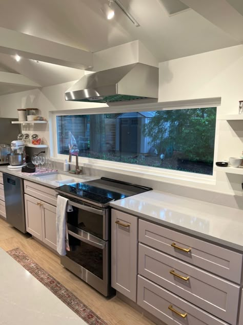 Kitchen Long Window Ideas, Small Kitchen With Big Window, Long Window Over Kitchen Sink, Kitchen Stove Near Window, Double Window Kitchen, Stove By The Window, Window Behind Stove Range Hoods, Kitchen Stove Window, Stove With Window Behind It