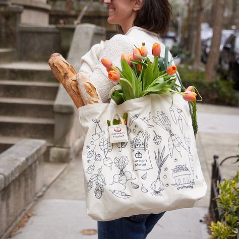 We made a bag with our friends at Winter Water Factory! Cut, Sewn and Printed down the street from us in Winter Water Factory's local Brooklyn studio, this fun oversized tote features illustrations of our new fruit and veggie ornaments. Check out more from Winter Water Factory here. Made locally in Brooklyn with up-cycled cotton canvas. Features black line illustrations of our Farmer's Tote Bag Ornament, Pick Your Own Blueberry Basket, Strawberries, Cherries, Beaded Peapod, Carrot, Radish, Garli Basket Strawberries, Blueberry Basket, Garlic Corn, Tote Bag Illustration, Farmers Market Tote Bag, Water Factory, Winter Tote, Line Illustrations, Garden Tote Bag