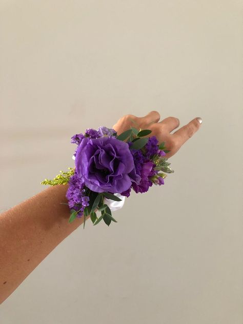 Purple Wrist Corsage Prom, Purple And Gold Corsage, Corsage For Purple Dress, Prom Flowers Corsage Purple, Dark Purple Corsage And Boutonniere, Purple And Blue Corsage, Purple And Black Corsage, Dark Purple Corsage, Purple Prom Flowers