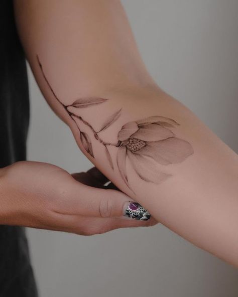 Magnolia Branch Tattoo Design, Single Line Magnolia Tattoo, Delicate Magnolia Tattoo, Flower That Represents Strength, Ambrosia Tattoo, Morning Glory Back Tattoo, Magnolia Wrist Tattoo, Magnolia Arm Tattoo, White Magnolia Tattoo