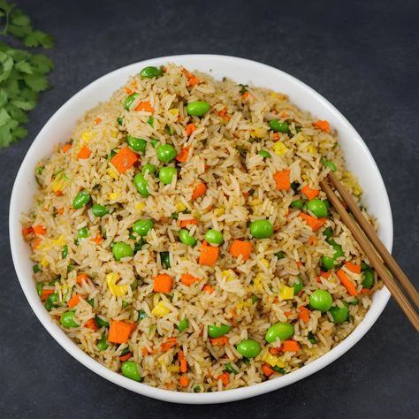 This recipe for vegetable fried rice is aromatic, delicious, and flavourful. Instead of ordering takeout, make this vegetable stir-fried rice. This tastes just like any restaurant version but is much healthier. By substituting different vegetables, this vegetable fried rice recipe can be adjusted to personal preference. Anyone who has children understands how difficult it is […] The post Vegetable Fried Rice appeared first on Scrumptiously. Fried Rice With Vegetables, Veg Fried Rice Recipe, Veg Fried Rice, Vegetable Fried Rice Recipe, Vegetarian Fried Rice, Vegetable Fried Rice, Hot And Sour Soup, Vegetable Rice, Delicious Vegetables