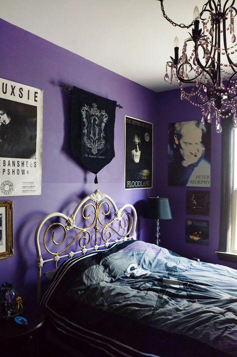 The guest bedroom is filled with vintage band posters and decor. The bed is vintage, purchased for Mollie when she was 13. Purple And Black Bedroom, Spooky Bedroom, Black Crystal Chandelier, Halloween Bedding, Goth Bedroom, Halloween Bedroom Decor, Pink Rooms, Gothic Room, Gothic Bedroom