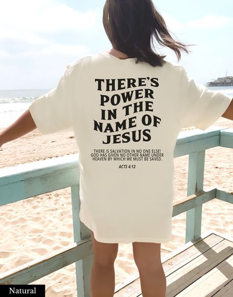 "Christian Shirt 👉 QUICK FACTS 👈 Bella Canvas 3001 Soft Cotton Solid colors are 100% combed and ring-spun cotton. Heather colors are 52% combed ring-spun cotton, 48% polyester Runs true to size. 👉HOW TO ORDER:👈 1. Please, Check and Review all Photos. 2. Select Your Size and Color from drop down menus. 3. Choose Your Quantity as much as you want. 4. Click \"Add To Cart\". For multiple items go back to the listing and repeat the steps. 👉Sizing Chart 👈 Use the sizing chart to understand the measurement of our Hoodies. 👉Care Instructions 👈 Machine wash: cold (max 30C or 90F); Non-chlorine Bleach as needed; Tumble dry: low heat: Iron, steam or dry: medium heat; Do not dry clean. 👉Returns👈 All items are made-to-order. Because of the nature of these items, unless they arrive damaged or Cotton Aesthetic, Acts 4 12, Bold Faith, In The Name Of Jesus, Christian Shirts Designs, Jesus Tees, Loose Tees, Christian Tees, Christian Shirt