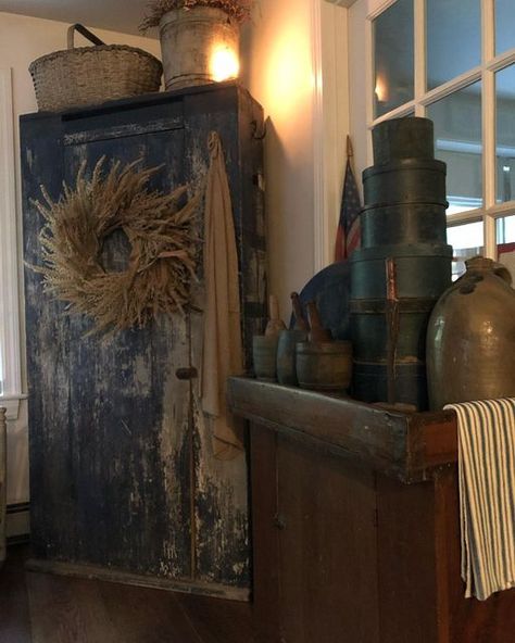 Rita on Instagram: "A bit of fall in a kitchen corner. #antiquecupboard #oldbluepaint #antiquedrysink #antiquebasket #antiquepantryboxes #antiquestoneware #fallwreath #primitivedecor #antiquesofinstagram #newenglandhome #capecodhome" Primitive Corner Cabinet, Corner Cabinet Ideas, Primitive Dry Sink, Colonial Primitive Decor, Primitive Cabinet, Antique Dry Sink, Primitive Home Decorating, Gothic Living Room, Primitive Cabinets