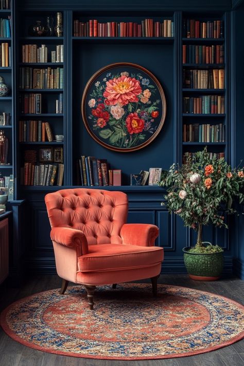 A dark blue wall with bookshelves, a pink velvet chair, and a floral painting in the style of the old money aesthetic. --ar 85:128 --v 6.1 --s 750 Dark Floral Interior, Dark Painted Bookshelves, Jewel Tone Home Library, Art Deco Library Room, Old Library Interior, Blue Orange Interior Design, Library Walls In Living Room, Emerald Green Library Room, Dark Teal Library