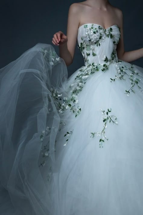 White Wedding Dress With Green Detail, Floral Train Wedding Dress, Wedding Dress With Dark Green Accents, Non Tradition Wedding Dresses, White Wedding Dress With Green Lace, Wedding Dress White And Green, Wedding Dress With Purple Flowers, Soft Wedding Dress Romantic, Wedding Dress With Coloured Flowers