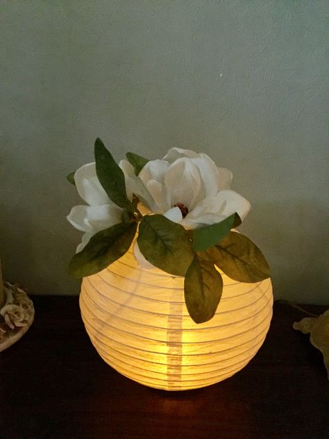 We used paper lanterns with a LED  tea light for centerpiece's at our class reunion. We hot glued a wide mouth bell jar lid on the bottom for a base so it would stand on the table. We used silk magnolias on the top to fill the hole. Paper Lantern Centerpieces, Diy Paper Lanterns, Princess Tiana Birthday Party, Tiana Birthday Party, Centerpieces For Weddings, Class Reunion Decorations, Reunion Decorations, Paper Lanterns Diy, Deco Champetre