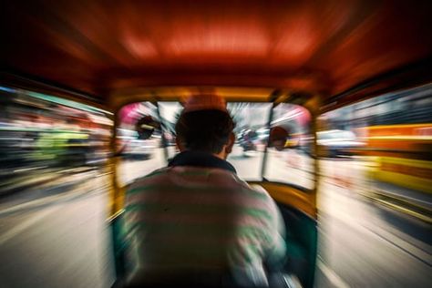 An auto rickshaw driver speeds down the street in New Delhi, India. I shot this image from the backseat with a slow shutter to achieve the zoomed effect for a sense of motion. Canon EOS 6D, 16-35mm f/2.8 lens @ 16mm, 1/40s @ f14, ISO 160, handheld. Contrast, curves and levels adjustment, sharpening in Photoshop CC. Photo © Drew Hopper. Slow Shutter Speed Photos, Slow Shutter Speed Photography, Auto Rickshaw, Panning Shot, Shutter Speed Photography, Panorama Photography, Old Delhi, Australian Photography, Photography Assignments