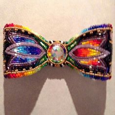 Beaded bow by woodro roandashian Native American Beadwork Patterns Hair Barrettes, Beaded Regalia, Beaded Bear, Powwow Beadwork, Bead Hat, Native American Beadwork Patterns, Native Beading, Beaded Bow, Make A Bow