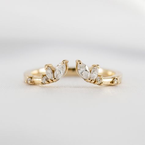 The organic design of our Claire marquise wedding ring perfectly complements round, oval, pear, or marquise engagement rings. A distinctive open center creates a contemporary feel, allowing for a seamless fit with your engagement ring. If you love a more dramatic look, the Claire wedding band is spectacular in pairs, flanking the engagement ring on top and bottom. Meticulously handcrafted for a perfect fit, the diamond-dotted Claire marquise wedding makes an original yet elegant choice. Metals: Marquise Engagement Rings, Asymmetrical Engagement Ring, Marquise Eternity Band, Double Wedding Bands, Open Wedding Band, Marquise Wedding Ring, Round Wedding Band, Marquise Shape Diamond, Future Engagement Rings