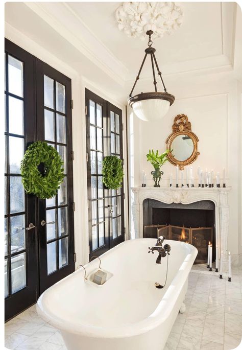 My heart's desire is a wood-burning fireplace in a bathroom bathed in light. #Designer@DarrylCarter is my #decor hero; his ability to create timeless rooms, blending the best of #vintage & antique, uber-modern streamlined simplicity, classic materials & palettes, in light-drenched rooms, never fails to inspire. #interiordesign #antiques #modern #bathroom #clawfoot #tub #wreath #decorating #classic #marble #fireplace #candlelight #light #interiors #white #simplicity #christmas Fireplace In Bathroom, Spa Bathroom Ideas, White Marble Tile Floor, Darryl Carter, Penny Tile Floors, Simple Bathroom Designs, Beautiful Bathroom Designs, White Marble Floor, Bath Inspiration