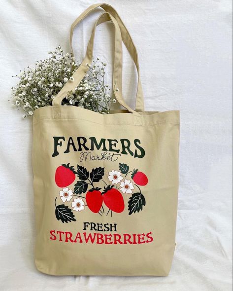 Canvas tote bag with the words farmers market fresh strawberries along with illustrated red strawberries and white flowers Strawberry Vibes, Strawberry Tote Bag, Physical Manifestation, Farmers Market Tote Bag, October Vibes, Strawberry Bag, Rain Aesthetic, Vegetable Bag, Totes Bag