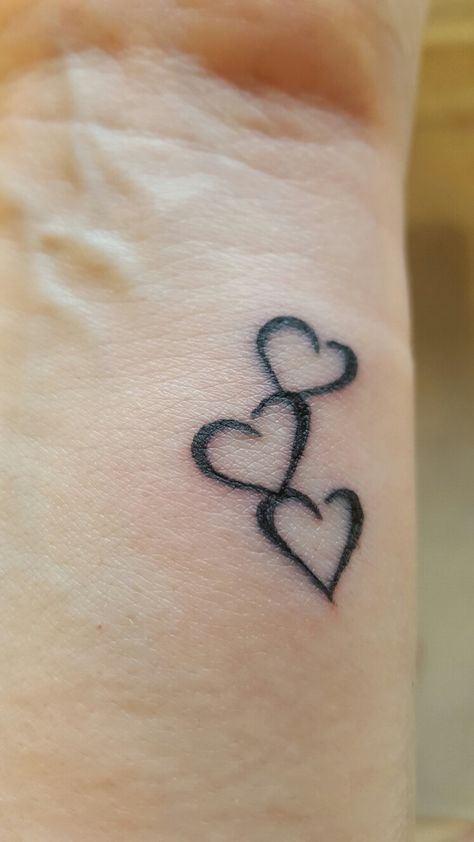 Three hearts to symbolise me, my husband and son. Kid Name Tattoo, Tattoo Placements, Tattoos With Kids Names, Three Hearts, Mother Tattoos, Tattoo For Son, Wrist Tattoo, Family Tattoos, Sister Tattoos