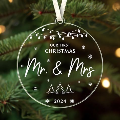 PRICES MAY VARY. Elegant Design: Crafted from high-quality acrylic, this ornament features a sleek, modern look with the heartfelt message "First Christmas as Mr & Mrs." Heartfelt Quote: Features the touching inscription "Our first Christmas married," making it a perfect keepsake for couples celebrating their first Christmas as newlyweds. This meaningful message will remind them of their special moment every holiday season. Perfect Gift: Ideal for newly married couples, this ornament is an excel Couple Keepsake Ideas, Wedding Christmas Ornaments, Gift Ideas Wedding, Mr And Mrs Ornament, Gift For Newlyweds, Wedding Gift Ideas, Gifts For Couples, First Christmas Married, Married Couples