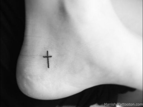 Aside from the more classic angel or praying hands, the wearing of religious symbolism on one’s body has long been a way to express faith, individuality, and identity. Ankle Tattoo Cross, Heel Tattoo, Cross Tattoo Meaning, Small Cross Tattoos, Small Cross Tattoo, Tattoo Foot, Cross Tattoos For Women, Faith Tattoo, Small Tattoos With Meaning