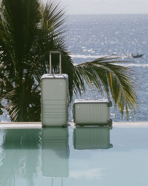 Sitting poolside, light dances across the metallic surface of our Silver Hybrid Carry-On and Hybrid Trunk. Photographed by @katherinemoff.at  #Monos #JourneyOn #MonosTravel #HybridCarryOn #HybridTrunk #HybridCollection #CarryOn #CarryOnLuggage #Travel #Traveller #TravelCompanion #TravelLover #TravelTheWorld #Suitcase #Luggage #PackYourBags #Design #IntentionalDesign #Silver Luxury Modern Double Handle Luggage, Luxury Coated Canvas Luggage, Modern Luxury Luggage For On-the-go, Luxury Functional Green Luggage, Luxury Modern Silver Luggage, Carryon Luggage, Premium Luggage, Summer Getaway, Travel Set