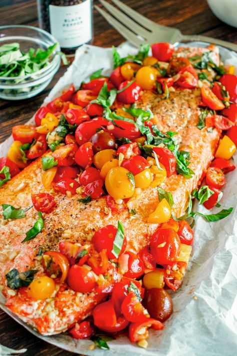 a photo of a side of cooked salmon topped with tomatoes and fresh basil Bruschetta Salmon, Best Baked Salmon Recipe, The Best Baked Salmon, Salmon With Tomatoes, Baked Salmon Filets, Best Baked Salmon, Healthy Salmon Dinner, Salmon Risotto, Salmon Bites Recipe