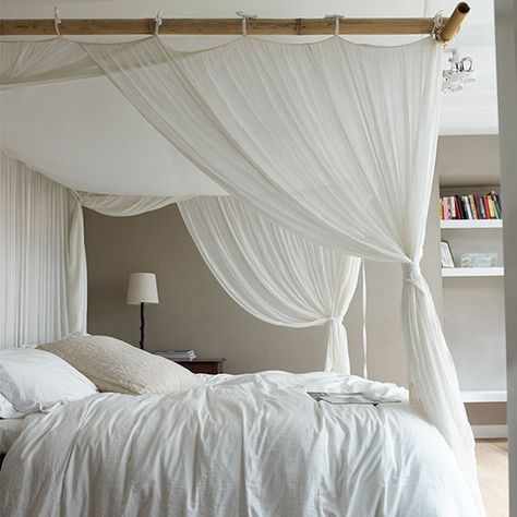 Four-poster bed with white canopy curtains, bedside table, light and shelving. Curtains Around Bed, White Canopy Bed, Neutral Bedroom Design, Canopy Bed Curtains, Neutral Bedrooms, White Canopy, Cool Curtains, Bed Canopy, Neutral Bedroom