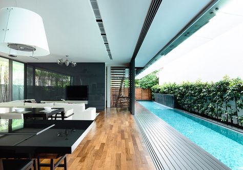 Formerly a semi-detached house, this site was converted to a bungalow. A lap pool is placed between the new house and the party wall, creating a private courtyard space. The 1st storey opens up to this space with the living, dining and dry kitchen adjacent. Upstairs, the master bathroom features a rainforest tree in the … Lap Pool Designs, Moderne Pools, Shaved Hairstyles, Chairs Diy, Block House, Piscina Interior, Indoor Swimming Pool, Half Shaved, Best Modern House Design