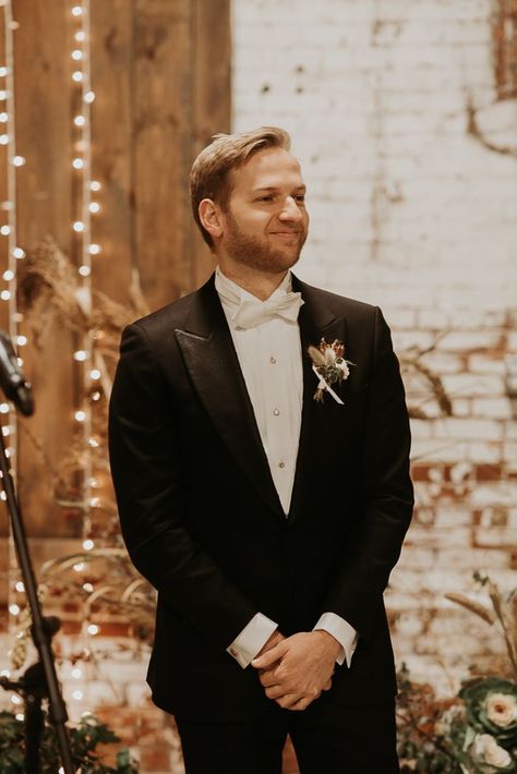 Classic black and white groom style with white bowtie | Image by Katelyn Mallett All Black Tux With White Bow Tie, Black Suit White Bow Tie, White Bowtie Groom, White Bow Tie Groom, Black Tux White Bow Tie, Black Tuxedo White Bow Tie, Groom Tuxedo White Bowtie, Groom White Jacket Black Lapel, Groom Black Tuxedo White Bowtie