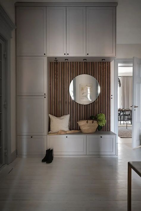 A light grey mudroom bench with a wood panel backdrop and drawers underneath the bench Entryway Shiplap Wall, Grey Wainscoting, Entryway Shiplap, White Painted Wood Floors, Classic Wall Panel, Light Grey Kitchen, Bench Cabinet, Historic Apartment, Entrance Hall Decor