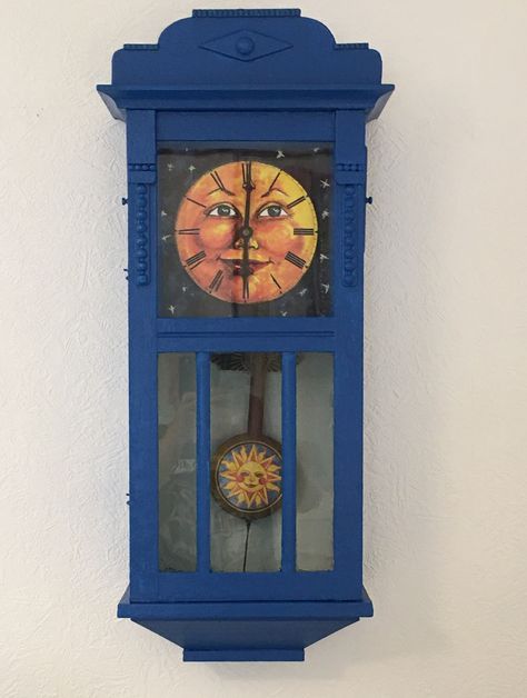 Old clock painted blue with moon face and sun pendulum. Upcycling Painted Clock Face, Painted Clock Ideas, Coocoo Clock, Painted Clocks, Clock Decor Ideas, Halloween Clock, Grandfather Clocks, Old Clock, Clock Painting