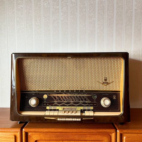 "Grundig 5088 Tube Radio Vintage Germany 1950s Original vintage condition with all authentic components. Fully funktional and working in all bands (AM, LW, KW and UKW). All mechanical components (such as knobs, rolls and tractions) were cleaned and oiled. All control knobs turns smoothly and all buttons are functional.  Dimensions: 67 x 40 x 28 cm (26.38\" x 15.75\" x 11.02\") Weight (Netto): 15 kg Please note: there are some minor scratches at the top, varnished surface. There is one torn thread on the fabric surface of the speaker. All these disadvantages are marked with red arrows. We are trying to make the product's descriptions as precise as possible, but still please note, that the offered items are usually pre-owned and rare vintage finds. That being said they may have some patina a Radio Vintage, Vintage Germany, All Band, Old Radios, Red Arrow, Miniature Projects, Vintage Wine, Milk Cans, Home Audio