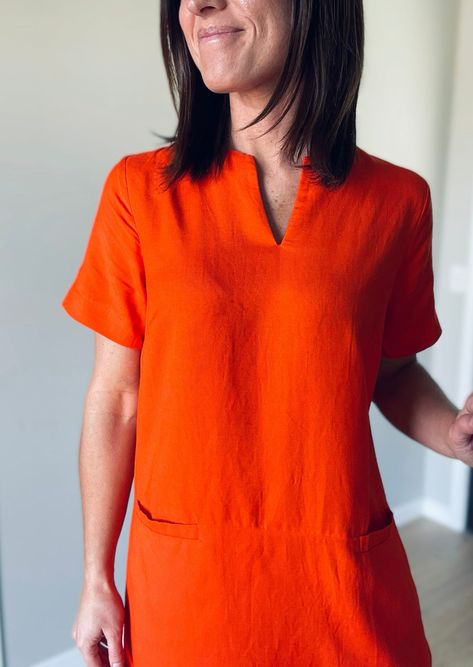 This linen Orange Shift Dress features a flattering mini v-neck and convenient pockets in the front. Its versatile shift dress style makes it perfect for both work and casual outings, easily dressed up with a blazer or down with sandals or tennis shoes. Material: 55% Linen, 45% Rayon Model: Wearing a size small 70s Casual Outfits, Short One Piece Dress, Dresses With Tennis Shoes, Dresses 70s, Linen Casual Dress, Shift Dress Styles, Short One Piece, Cotton Shift Dress, Linen Casual