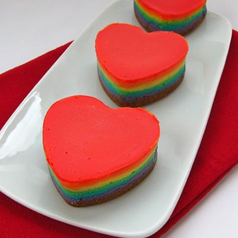 Add a rainbow of colors to to your Valentine's Day Desserts. These multi-colored Rainbow Cheesecake Hearts taste as great as they look. Heart Cake Pan, Rainbow Cheesecake, Heart Desserts, Rainbow Cookie, Valentines Breakfast, Heart Shaped Food, Frozen Cheesecake, Individual Desserts, How To Make Cheesecake