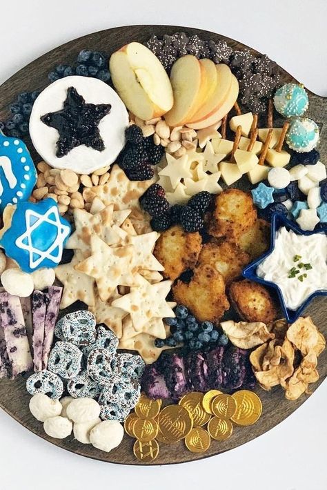 This Hanukkah charcuterie board has all the traditional charcuterie elements (cheese, crackers, fruit, and jam) but also includes some Hanukkah favorites—like latkes, chocolate gold coins, and dreidel-shaped cookies. #hanukkah #hanukkahcharcuterieboards #hanukkahideas #bhg Hanukkah Party Food, Hanukah Appetizers, Hannukah Recipes, Hanukkah Desserts, Hanukkah Traditions, Hanukkah Food, Chanukah Party, Large Family Meals, How To Celebrate Hanukkah