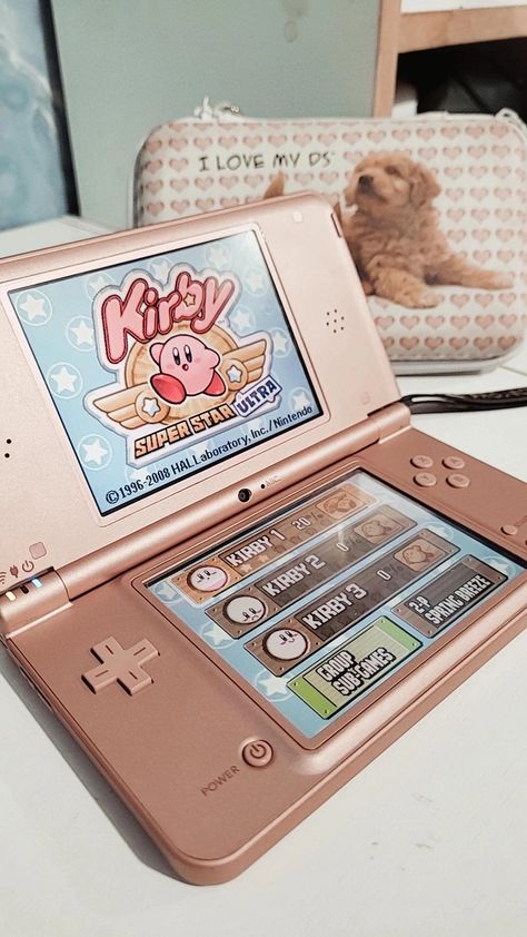 Nintendo DSi XL Metallic Rose playing the Kirby Super Star Ultra game, with a pink and white case for the DS. Dsi Xl Aesthetic, Nintendo 3ds Aesthetic, Nintendo Ds Aesthetic, Kirby Super Star Ultra, Christmas Gifts For Son, Nintendo Collection, Dsi Xl, Gifts For Son, Nintendo Dsi