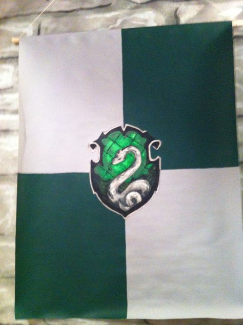 The Slytherin Banner I painted for the Great Hall.  This is the first one I painted and probably my favorite.  I used rolled canvas and acrylic paint.  I folded down the top and hung it with a dowel. Slytherin Painting Ideas On Canvas, Slytherin Canvas Painting, Slytherin Painting Ideas, Slytherin Painting, Slytherin Banner, Harry Potter Halloween Party, Boo Bash, Harry Potter Painting, Wizard Party