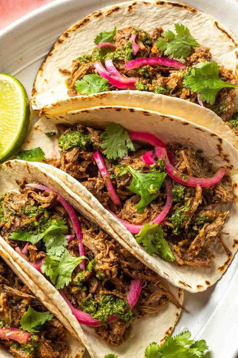 Slowly braised in citrus juice with onion and chipotle peppers, this lamb barbacoa makes the best lamb tacos. Serve them with toasted tortillas with a mint chimichurri and pickled onions for a simple, yet elegant main course. Lamb Barbacoa, Mint Chimichurri, Lamb Tacos, Lamb Taco, Chipotle Peppers, One Pot Dinners, Meat Dinners, Citrus Juice, Pickled Onions