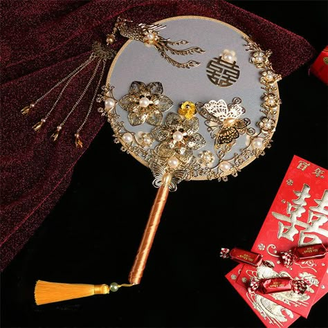 Enhance your traditional Chinese wedding ensemble with the bridal double happiness round hand Fan, adorned with intricate floral and phoenix designs and faux pearls. Experience a unique and traditional way of holding your fan instead of a bouquet. A perfect gift choice for a loved one! bridesmaids too. Fan Holder, Prop Reference, Ancient Chinese Characters, Chinese Umbrella, Sixteen Birthday Party Ideas, Disney Princess Castle, Bamboo Fan, Chinese Gifts, Traditional Chinese Wedding