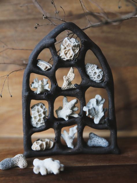 Hand-sculpted black clay curiosity cabinet. This shelf combines architectural elements of high gothic windows with biomorphic shapes inspired by the mollusk eyes. It is intended for displaying small objects measuring below 1 inch in the largest dimension. The listing price is for the ceramic shelf and does not include corals and other display items shown in the photos. The shelf was made in a small smoke-free studio in the middle of Brittany, France. The design is unique and absolutely one-of-a- Interactive Ceramic Art, Ceramic Houses Ideas, Weird Ceramics, Office Altar, Ceramic Architecture, Biomorphic Shapes, Ceramic Shelf, Black Ceramics, Gothic Windows