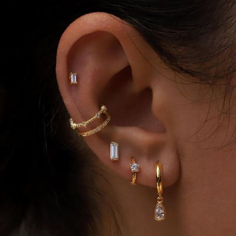 Pinch & Fold on Instagram: "Today’s ear party featuring some of our simple and classic designs. 💕✨💫 Styled with our Crystal Teardrop huggies, Solitaire huggies, Omni studs, Ria cuff and Omni piercing." Gold Helix Piercing, Conch Ear Piercing, Rectangular Earrings, Pretty Ear Piercings, Diamond Baguette, Diamond Cluster Earrings, Ear Party, Tragus Piercing, Opal Studs