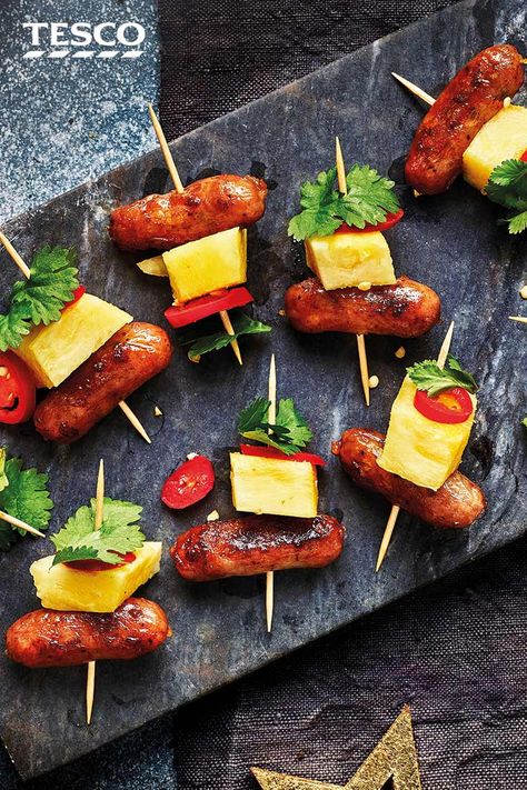 Layer up sticky honey glazed cocktail sausages with juicy pineapple, spicy chilli and coriander for these colourful Hawaiian skewers - a party-pleasing canapé. | Tesco Hawaiian Skewers, Sausage And Pineapple, Cocktail Sausage Recipes, Beach Party Food, Pineapple Skewers, Christmas Canapes, Sausage Appetizers, Spicy Chilli, Cocktail Sausages