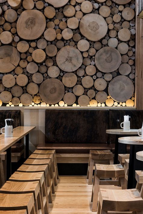 Accent Wall Ideas - 12 Different Ways To Cover Your Walls In Wood // The cross sections of tree stumps displayed on this wall bring in warmth and mimic the natural look of a forest floor. Wood Feature Wall, Log Wall, Rustic Bar, Into The Wood, Bar Interior, Tables And Chairs, Restaurant Interior Design, Into The Woods, Hospitality Design